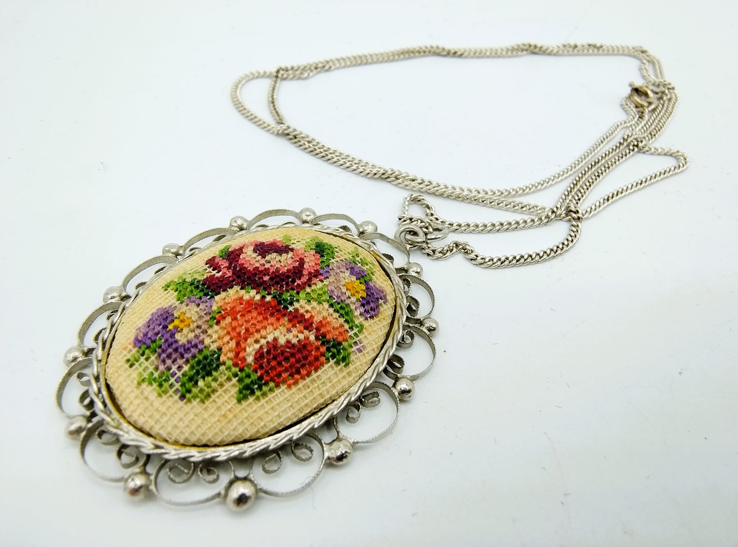 Zilveren ketting met onedele hanger met borduurwerk