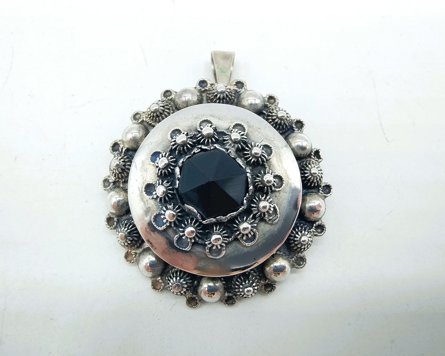 Silver brooch or pendant set with Zeeland buttons and a jet.