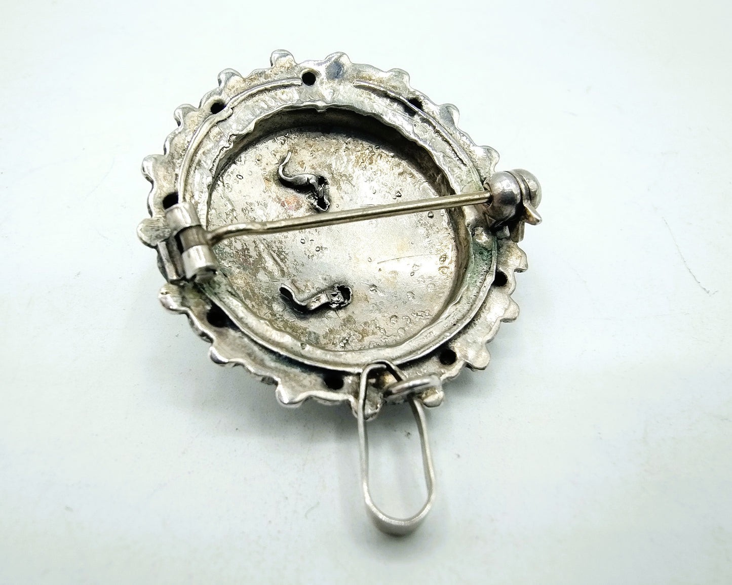 Silver brooch or pendant set with Zeeland buttons and a jet.