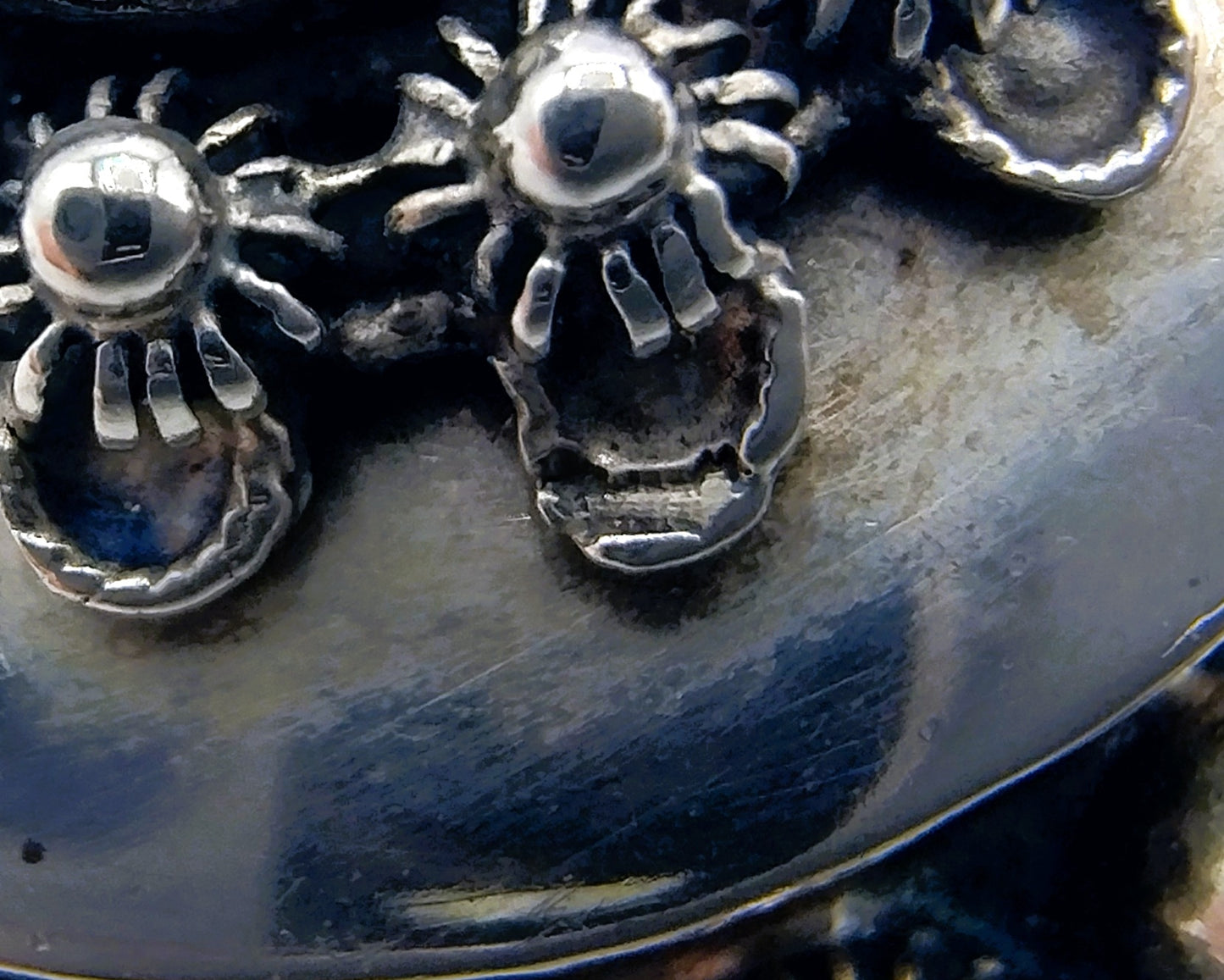 Silver brooch or pendant set with Zeeland buttons and a jet.