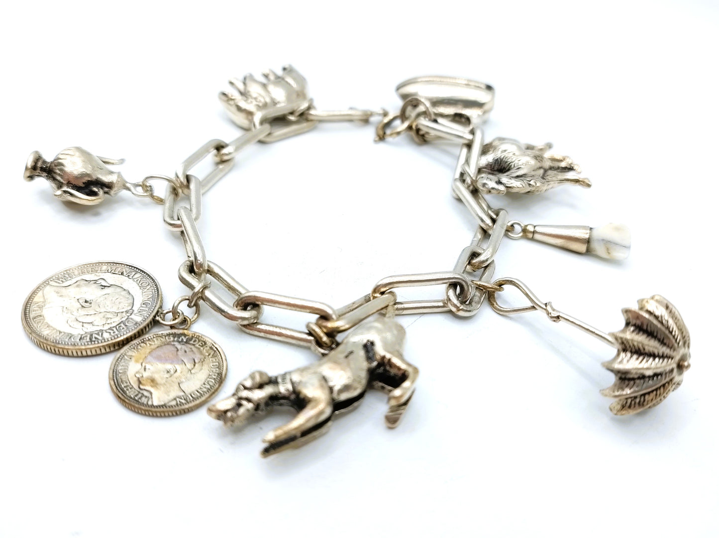 Heavy silver charm bracelet with 9 charms.