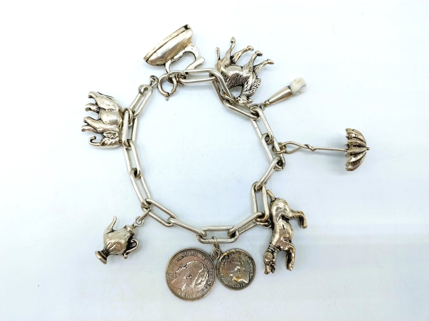 Heavy silver charm bracelet with 9 charms.