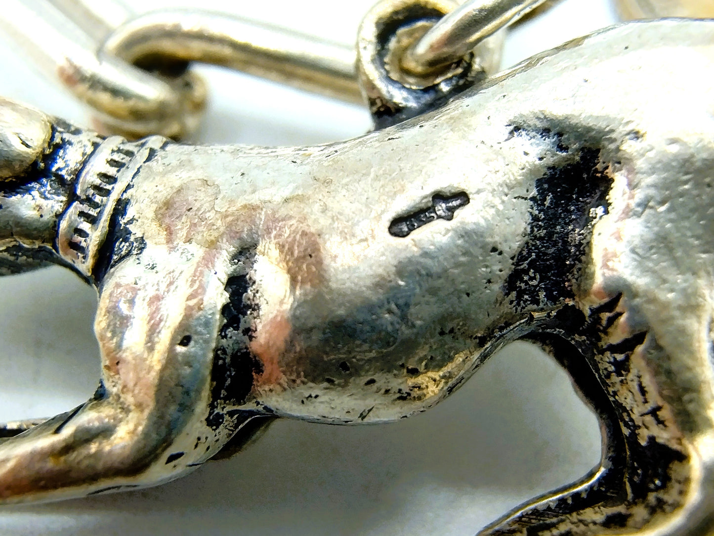 Heavy silver charm bracelet with 9 charms.
