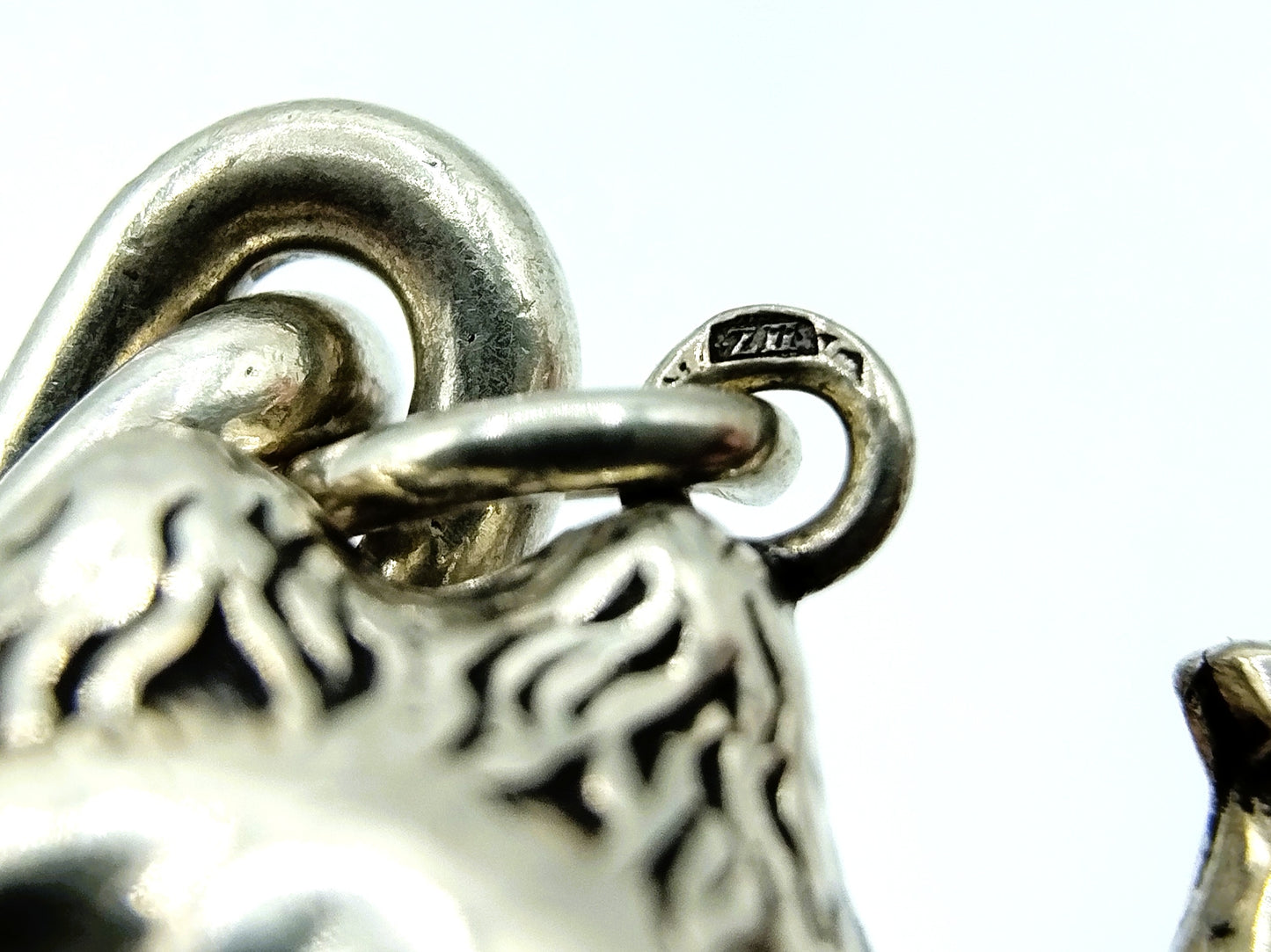 Heavy silver charm bracelet with 9 charms.