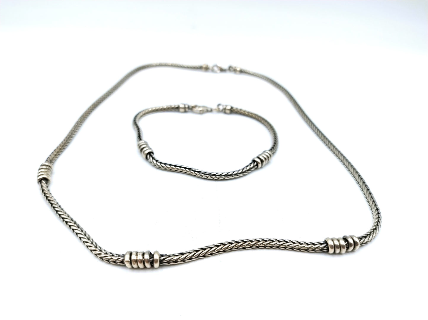 Silver chain + bracelet, snake motif.