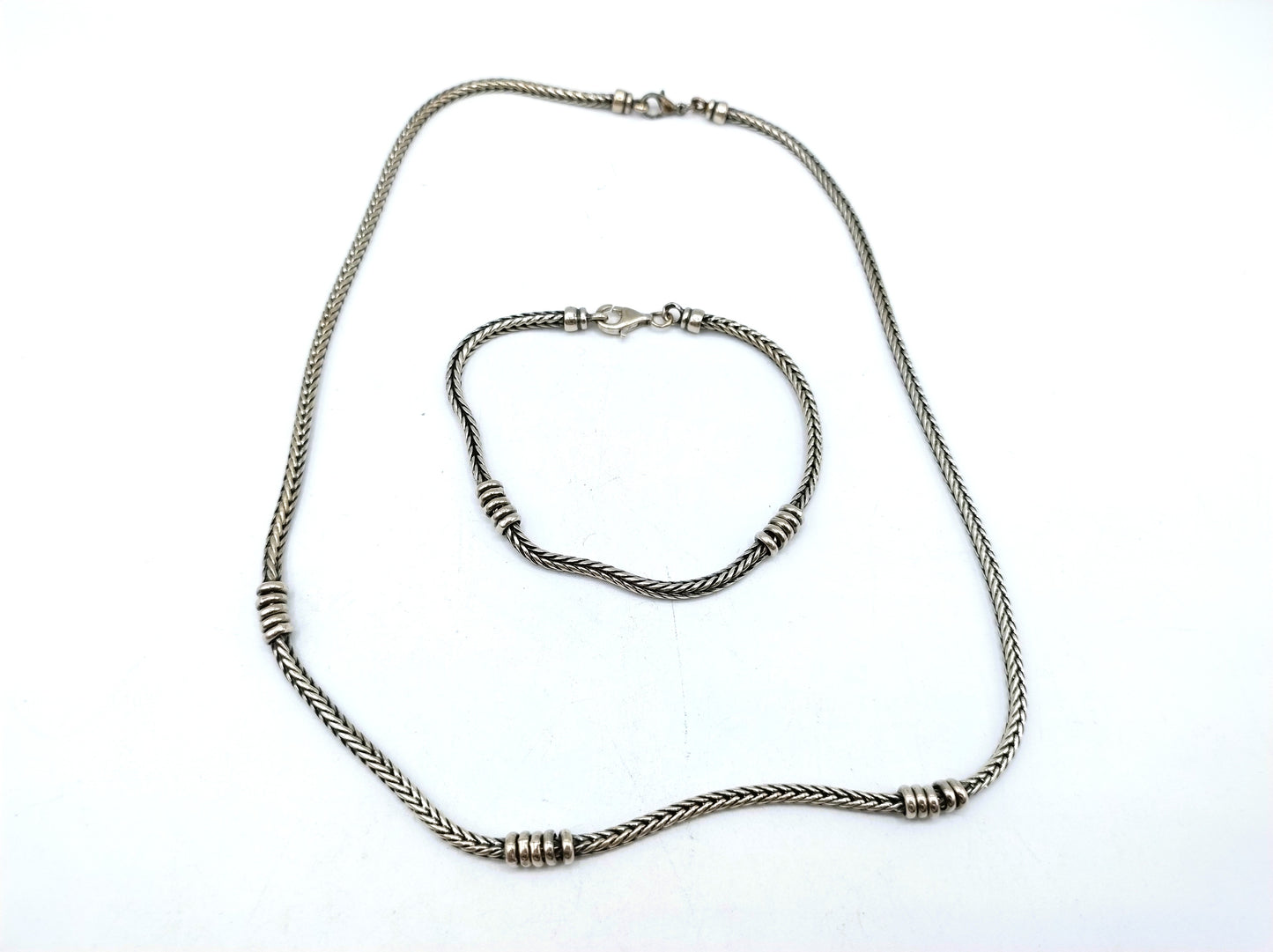 Silver chain + bracelet, snake motif.