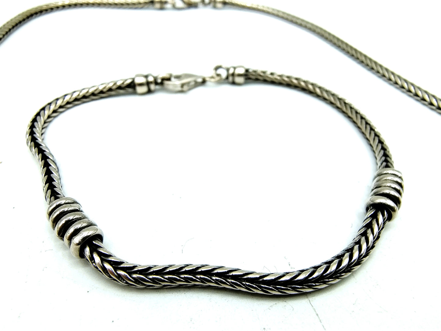 Silver chain + bracelet, snake motif.