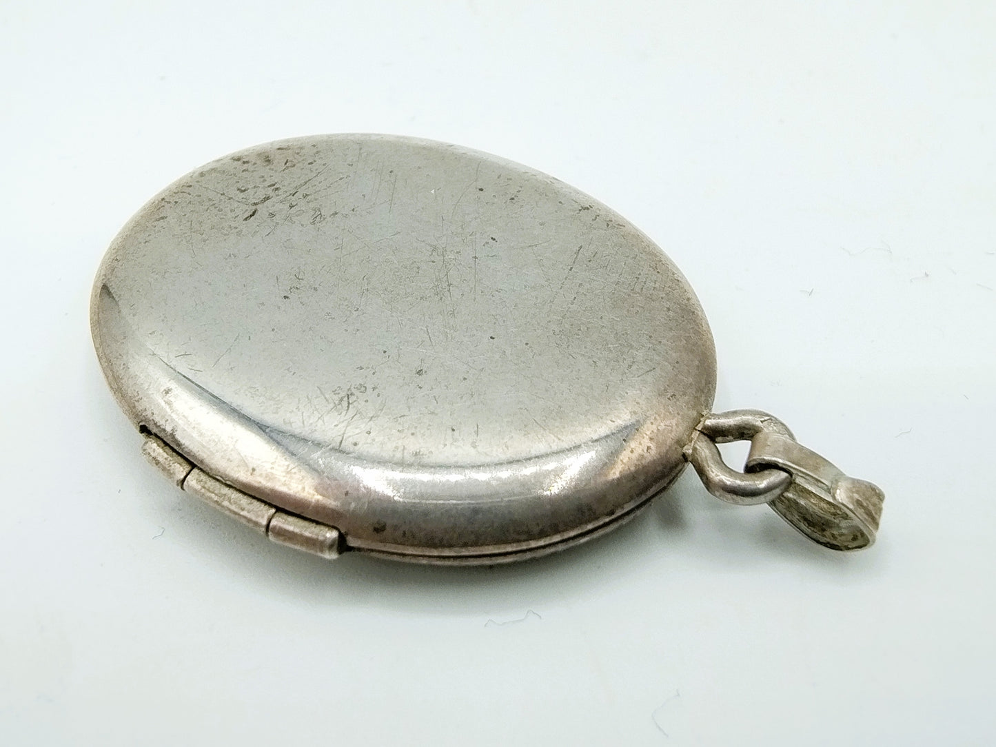 Silver medallion with flowers.