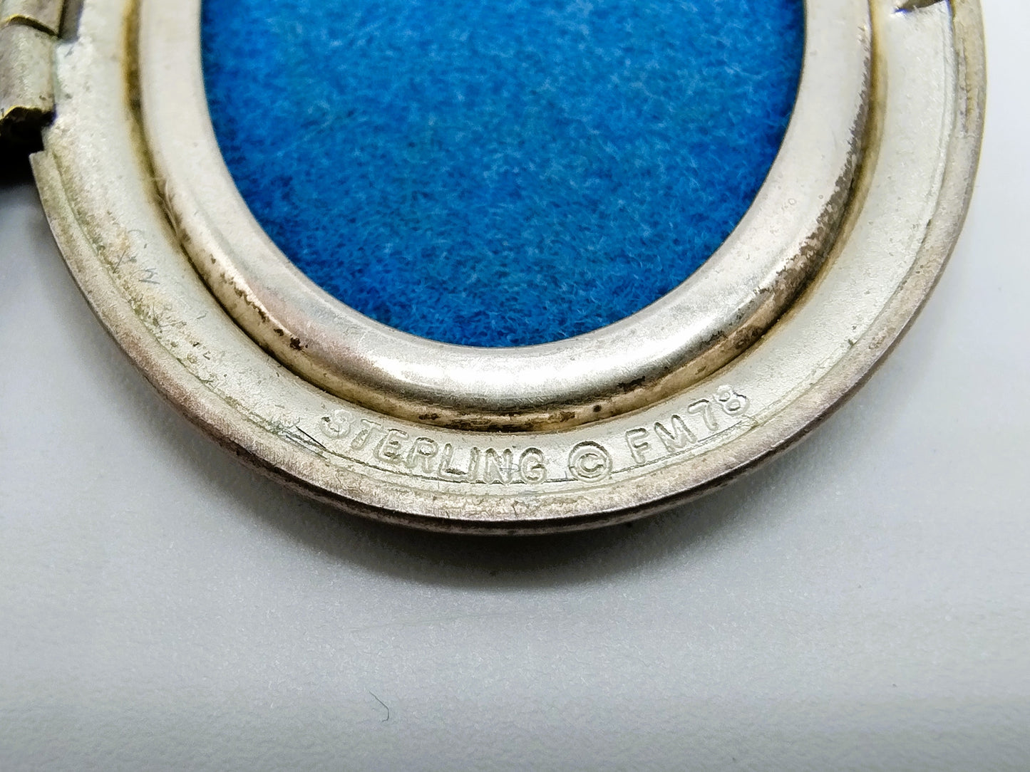 Silver medallion with flowers.