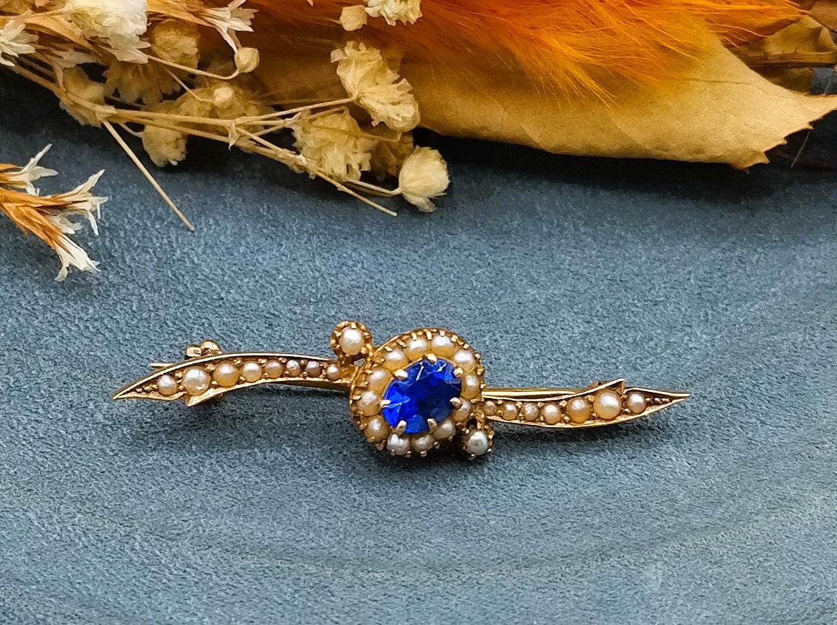 Gold brooch set with sapphire and saltwater pearls.