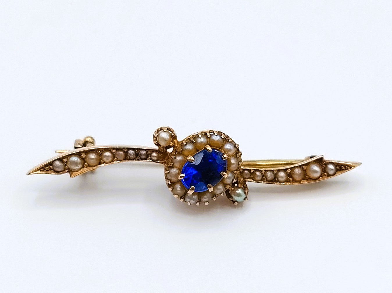 Gold brooch set with sapphire and saltwater pearls.