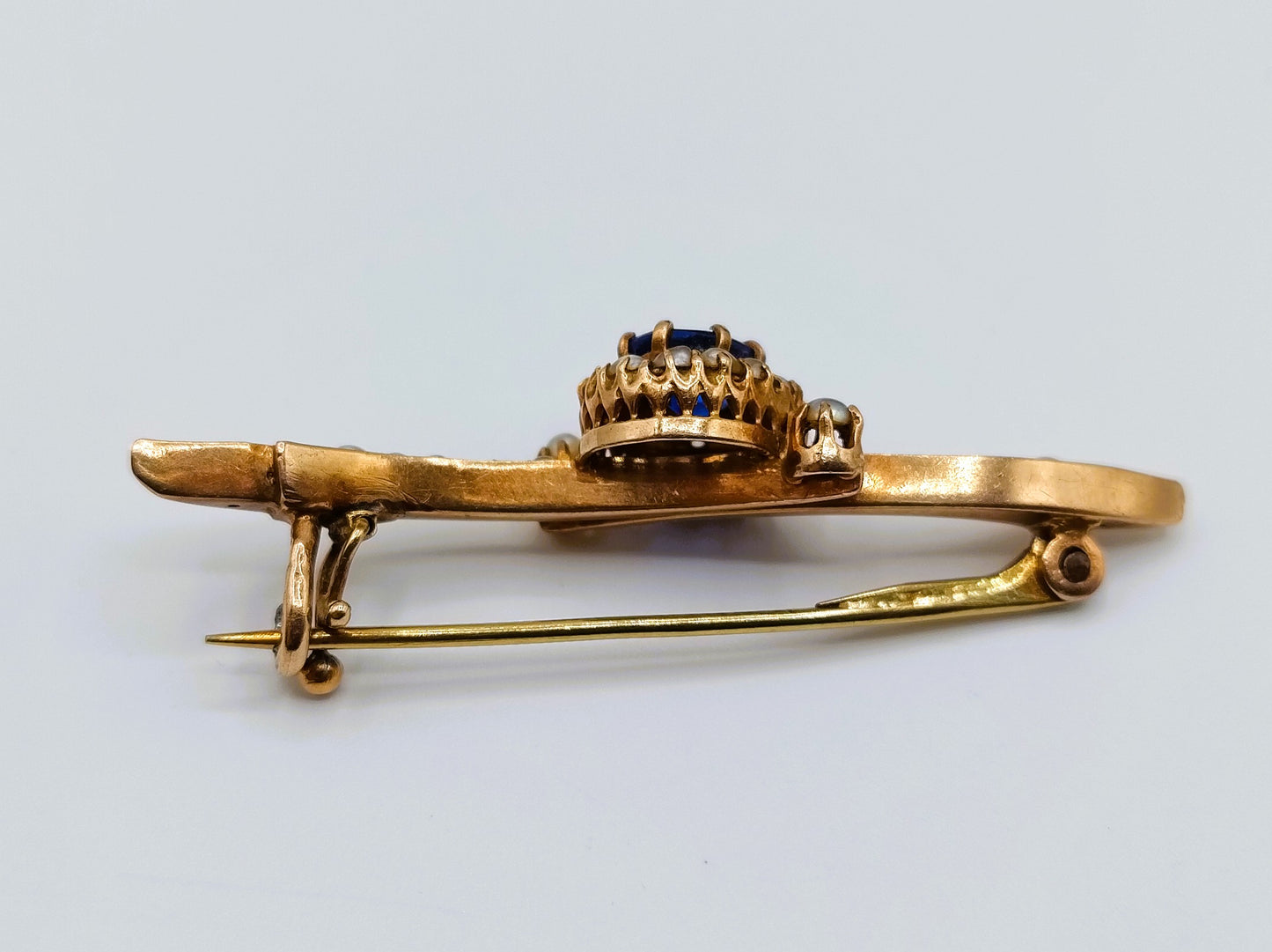 Gold brooch set with sapphire and saltwater pearls.