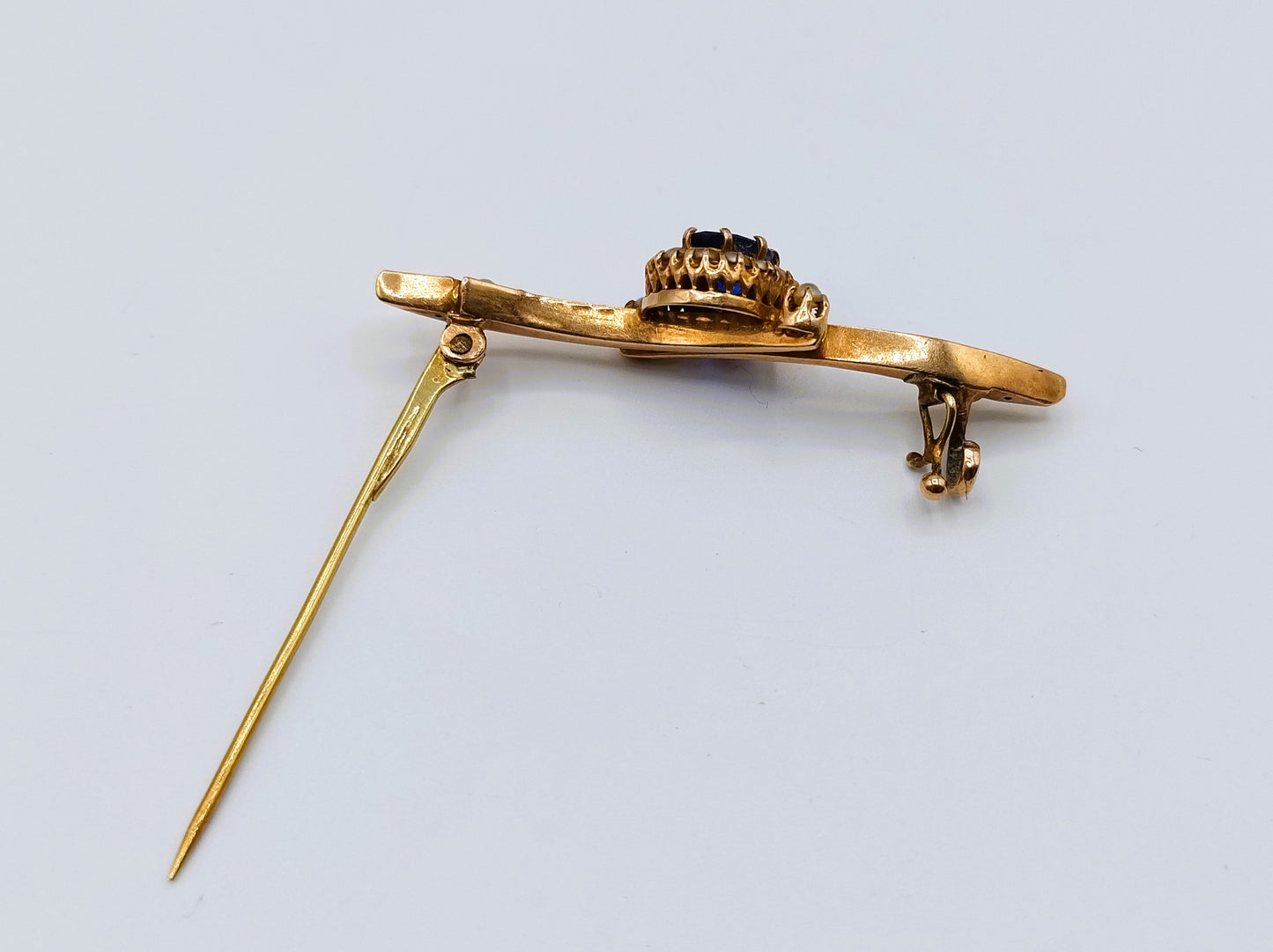 Gold brooch set with sapphire and saltwater pearls.