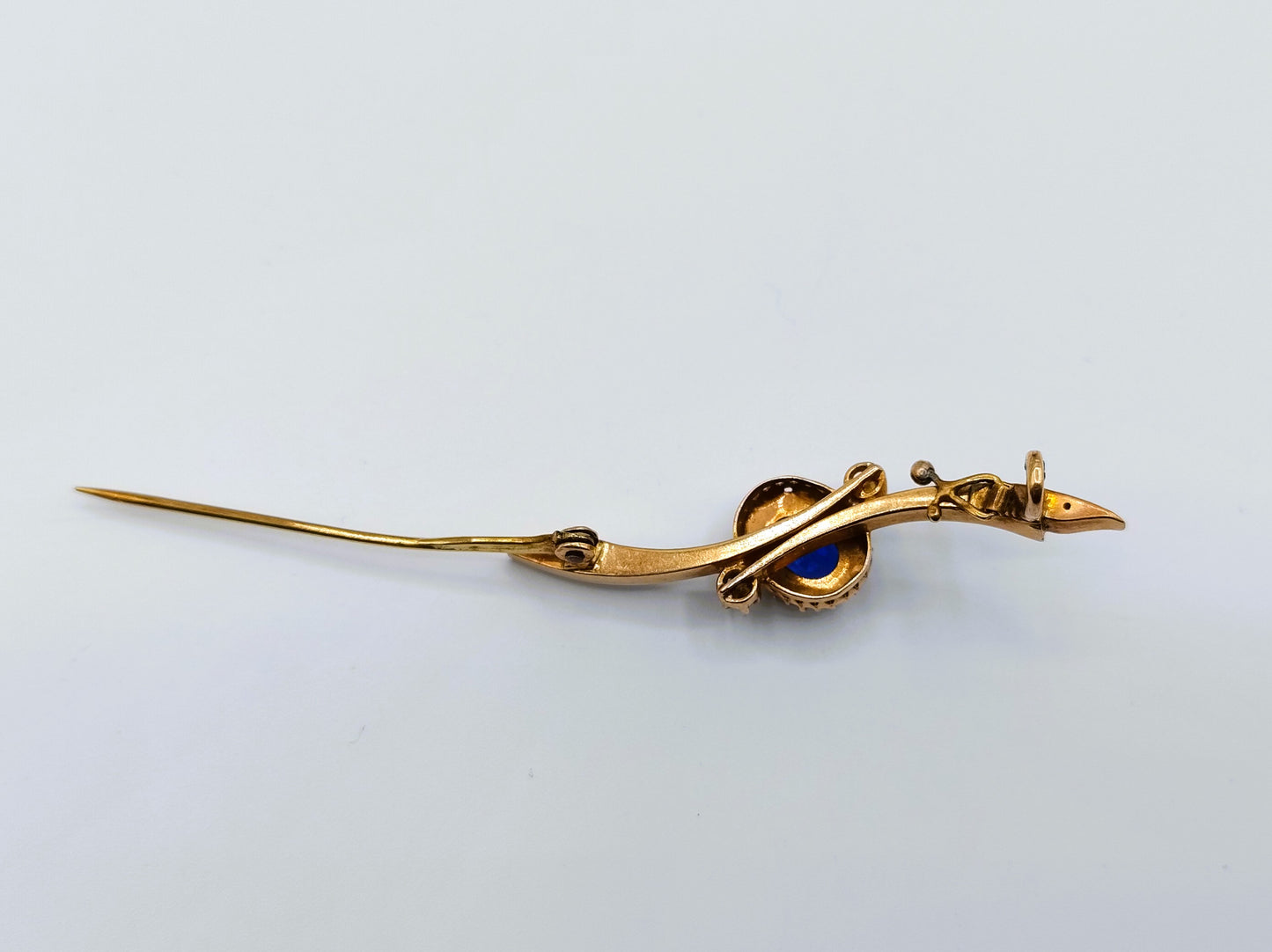 Gold brooch set with sapphire and saltwater pearls.