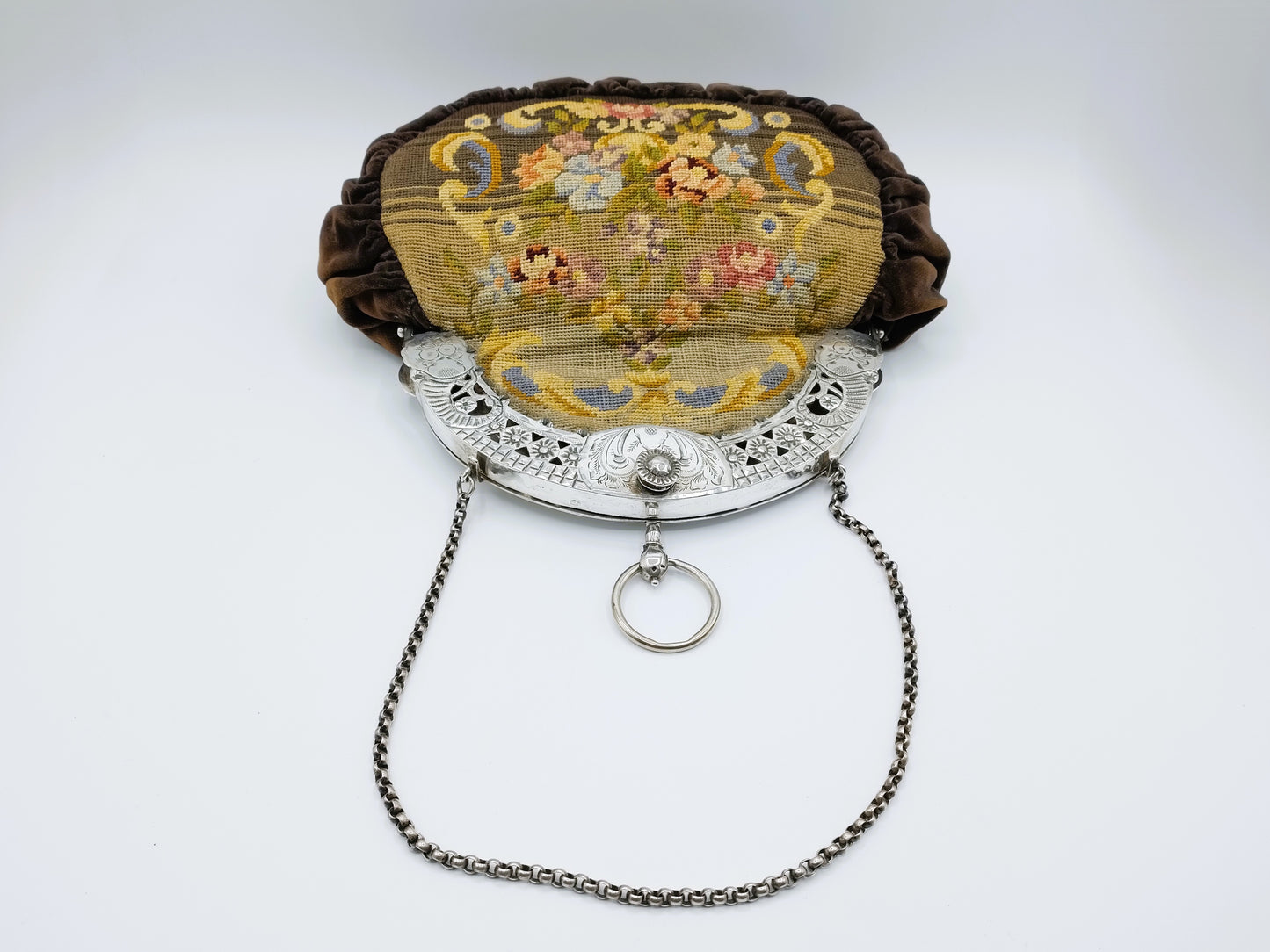 Petit Point bag with silver handle.