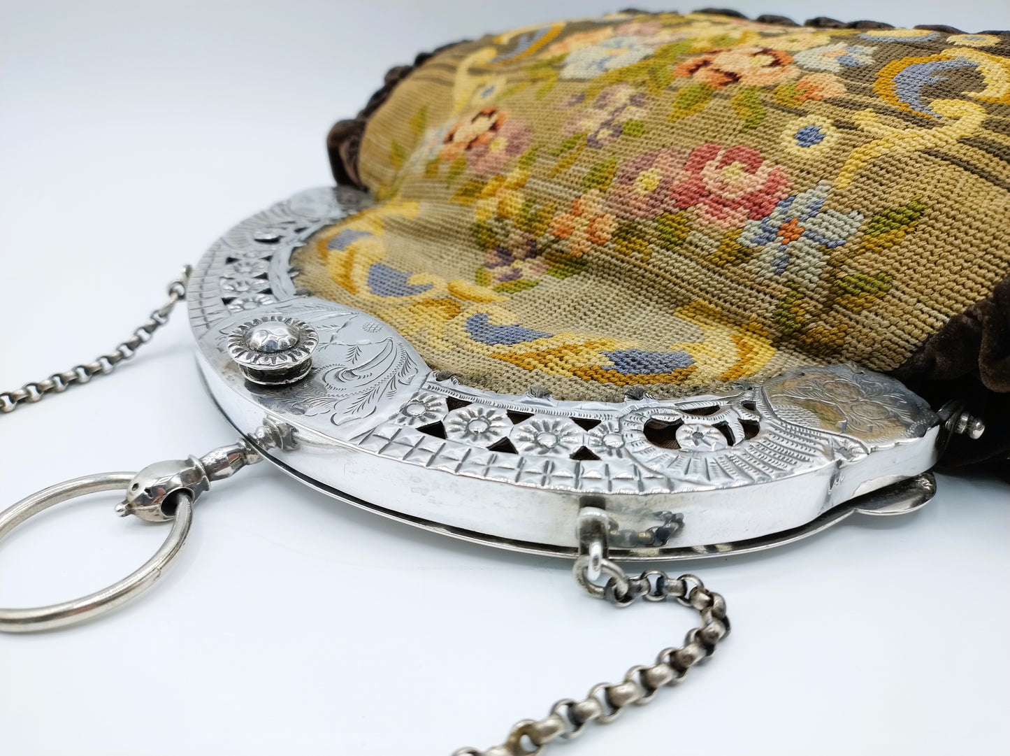 Petit Point bag with silver handle.