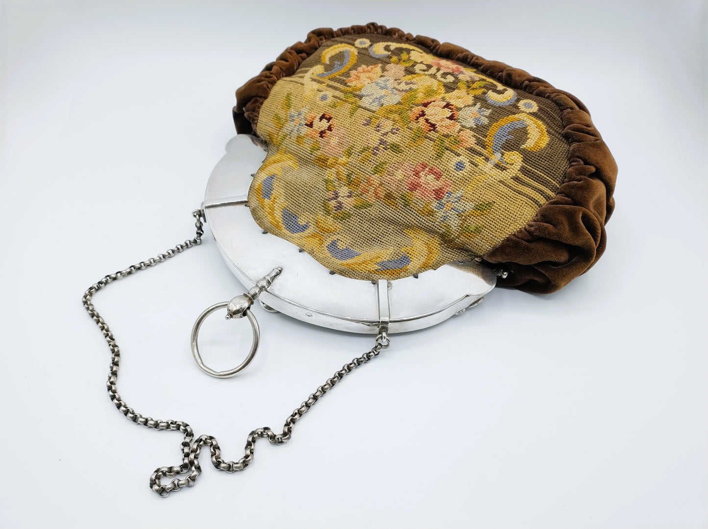 Petit Point bag with silver handle.