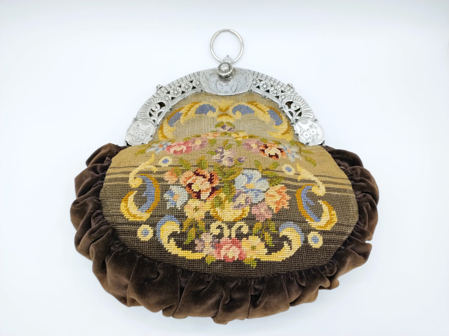 Petit Point bag with silver handle.