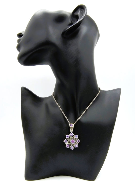 Silver pendant set with brilliant cut purple stones