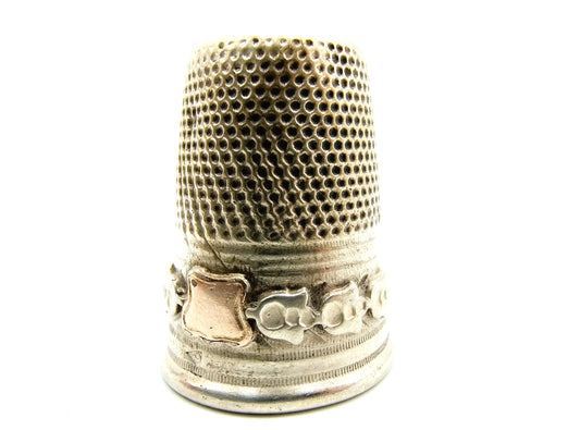 Silver thimble with gold shield, 19th century