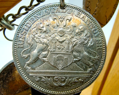 Display cabinet with 15 antique German coins, 16th to 19th century