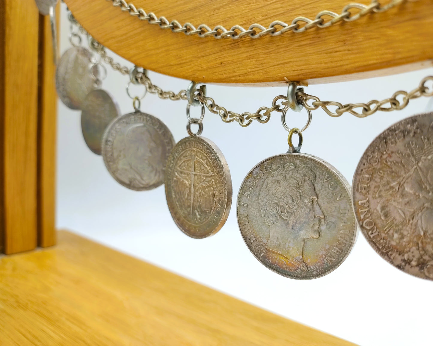 Display cabinet with 15 antique German coins, 16th to 19th century