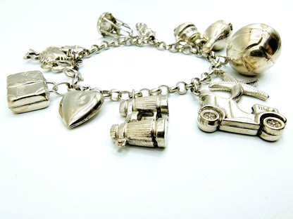 Silver charm bracelet with 11 charms, 18 cm