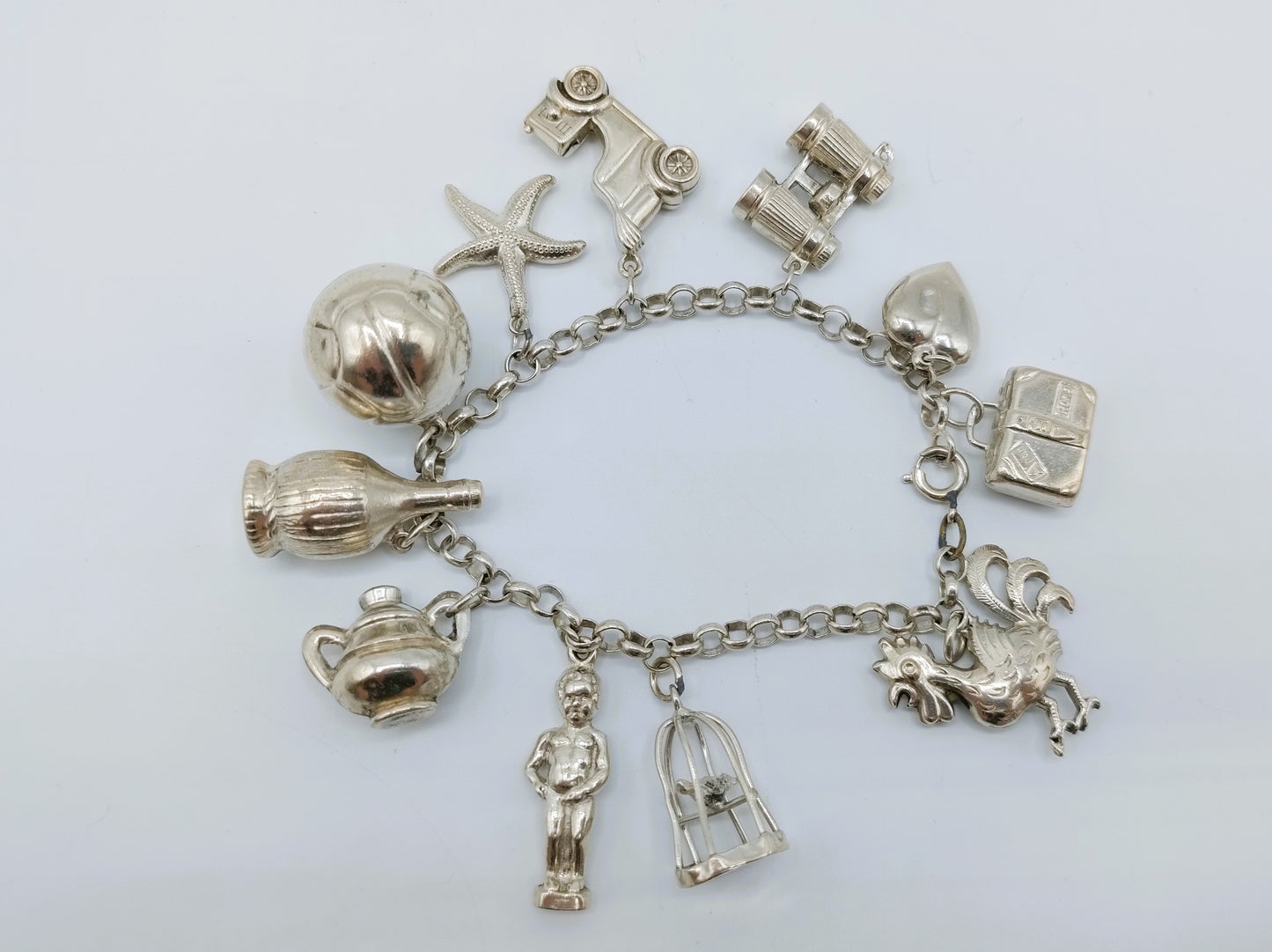 Silver charm bracelet with 11 charms, 18 cm