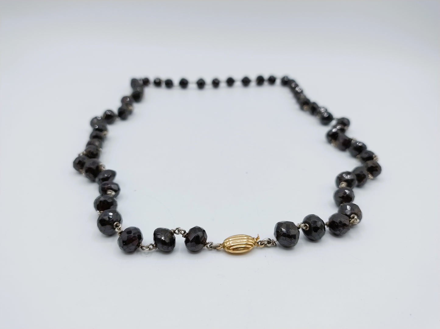 Garnet necklace with gold clasp.