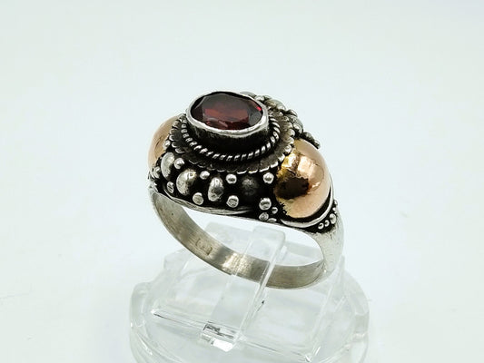 Silver ring with gold accents and garnet, 18 mm