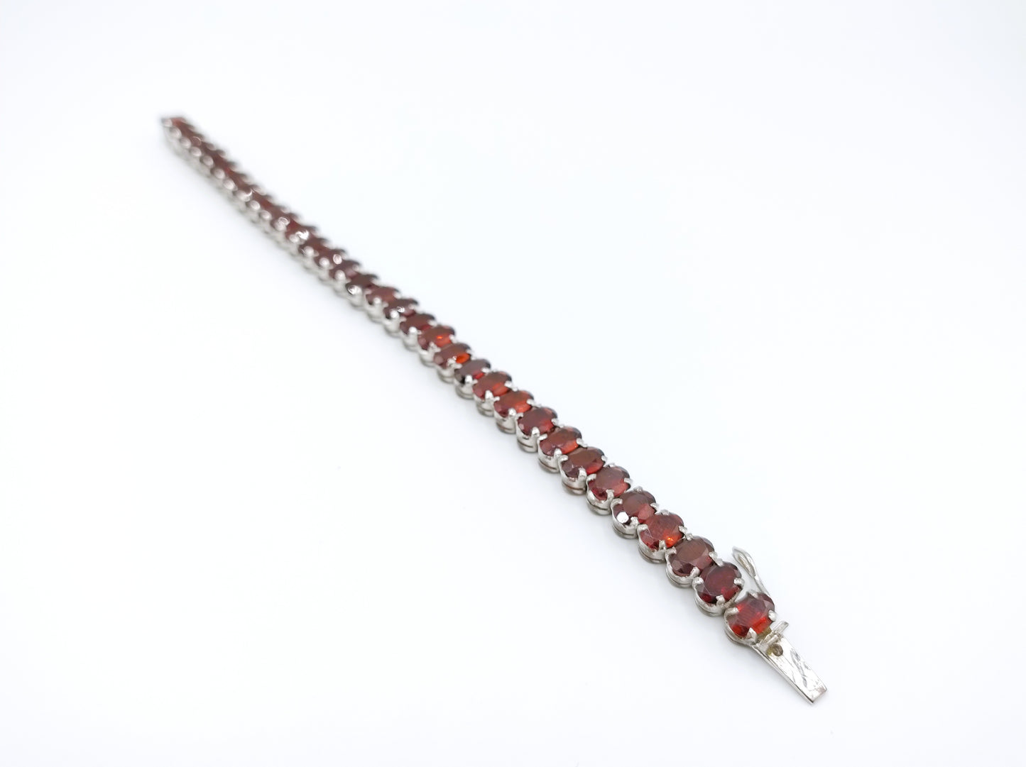 Silver tennis bracelet with red stones, 17.5 cm