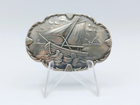 Silver brooch with botters