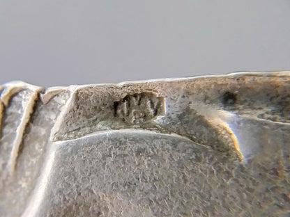 Silver brooch with botters