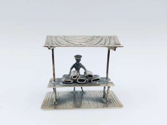 Silver miniature fabric seller