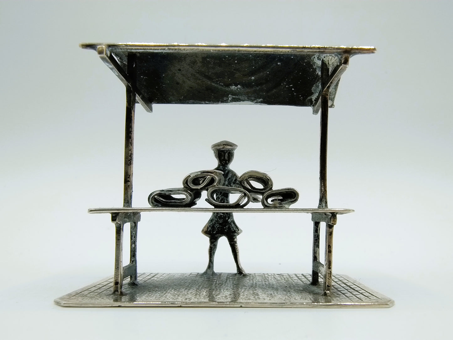 Silver miniature fabric seller