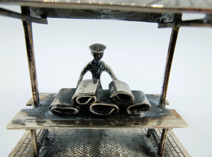 Silver miniature fabric seller