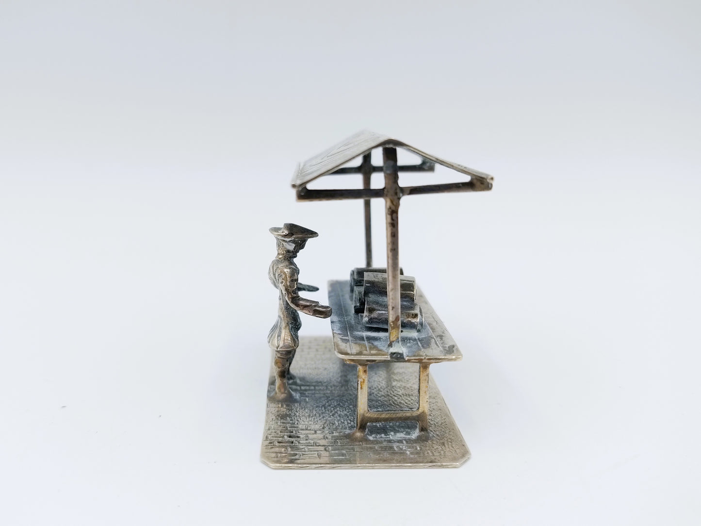 Silver miniature fabric seller