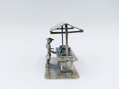 Silver miniature fabric seller