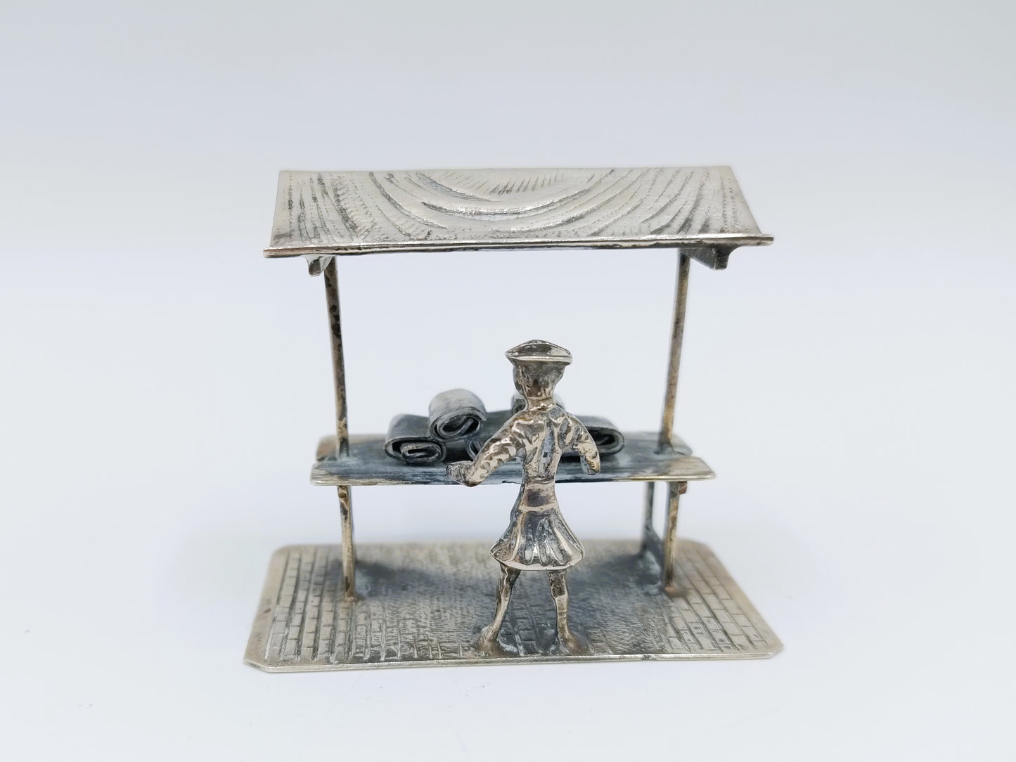 Silver miniature fabric seller