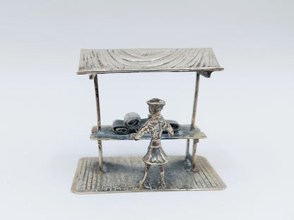 Silver miniature fabric seller