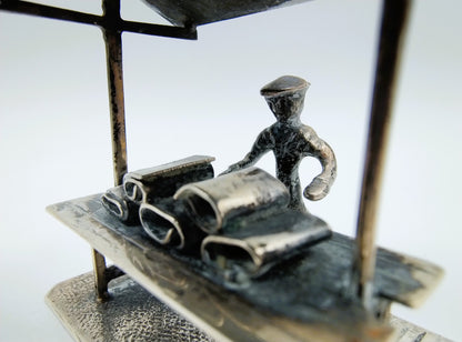 Silver miniature fabric seller