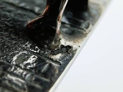 Silver miniature fabric seller