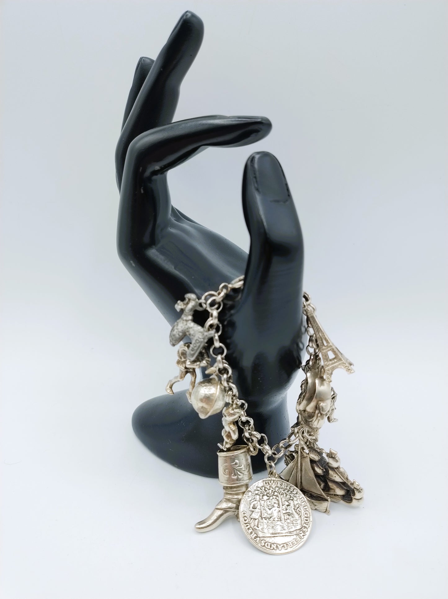 Zilveren bedelarmband met 13 bedels, o.a. penning uit 1766, 17 cm