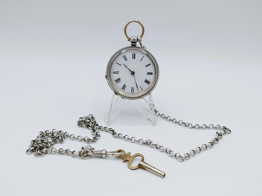 Silver pocket watch with watch chain and key