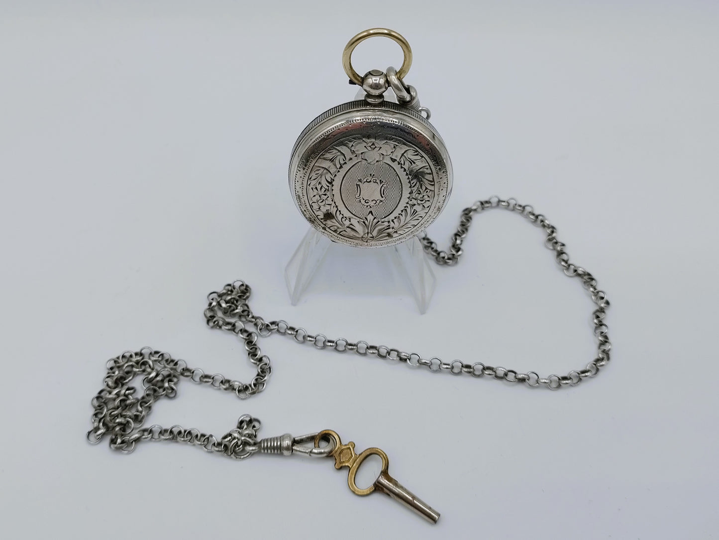 Silver pocket watch with watch chain and key
