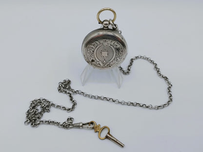 Silver pocket watch with watch chain and key