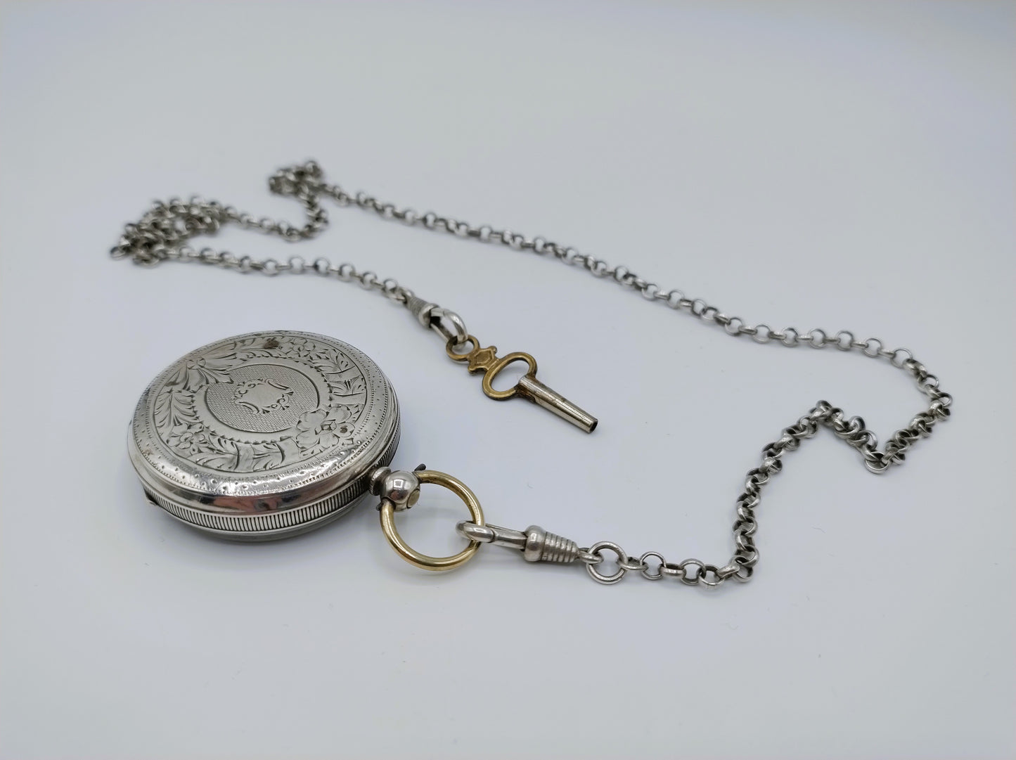 Silver pocket watch with watch chain and key