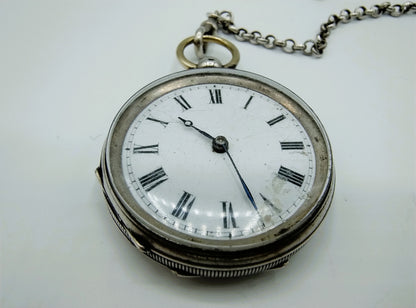 Silver pocket watch with watch chain and key