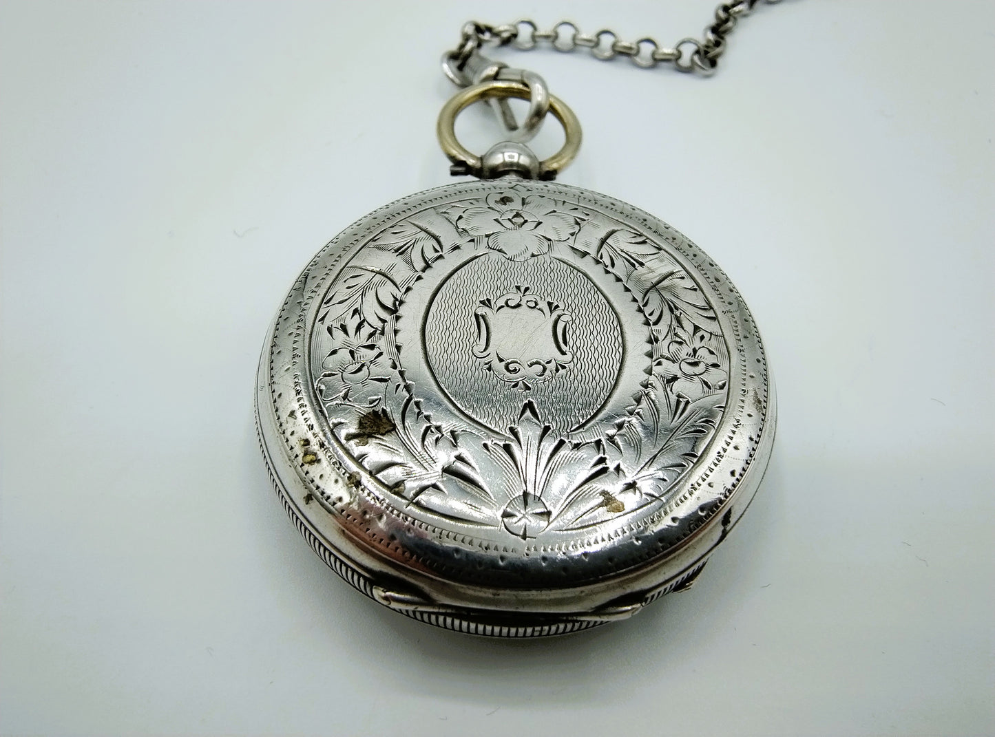 Silver pocket watch with watch chain and key
