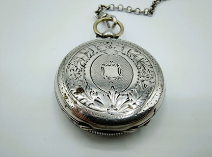 Silver pocket watch with watch chain and key